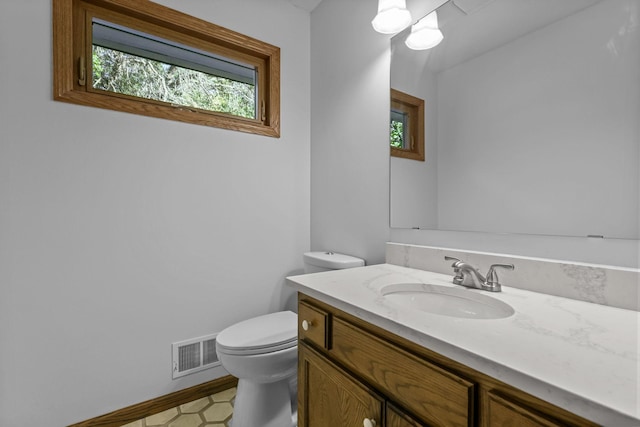 bathroom featuring toilet and vanity