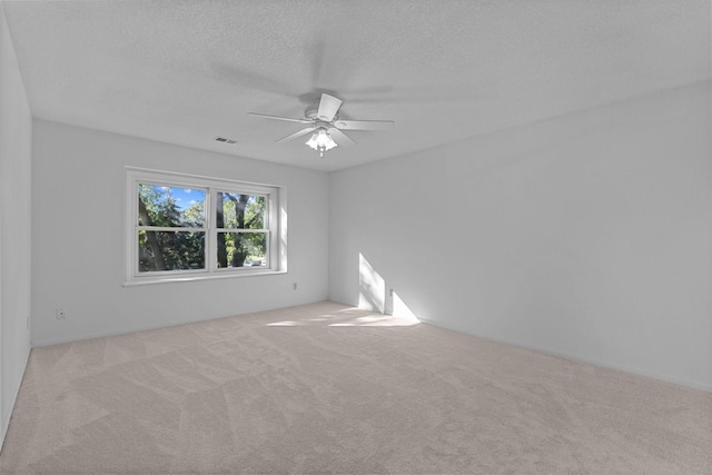 unfurnished room with light carpet, a textured ceiling, and ceiling fan