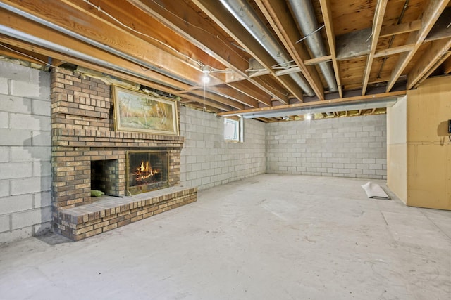 basement featuring a brick fireplace