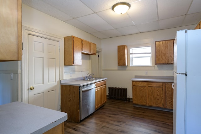 kitchen featuring dark hardwood / wood-style flooring, stainless steel dishwasher, radiator, sink, and white refrigerator