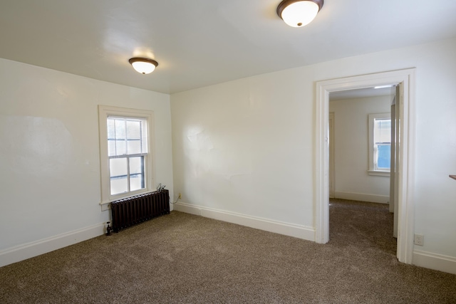 carpeted spare room with radiator