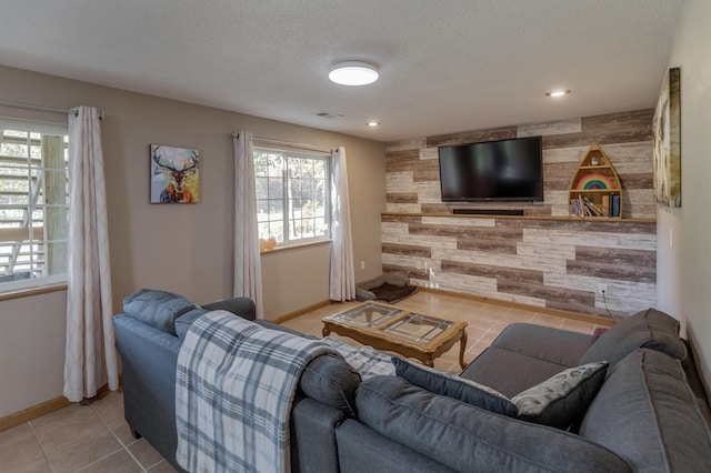 tiled living room featuring a textured ceiling and wooden walls