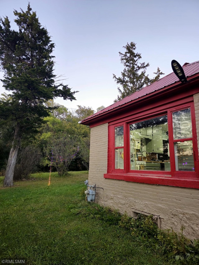 view of property exterior with a yard