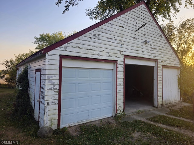 view of garage at dusk