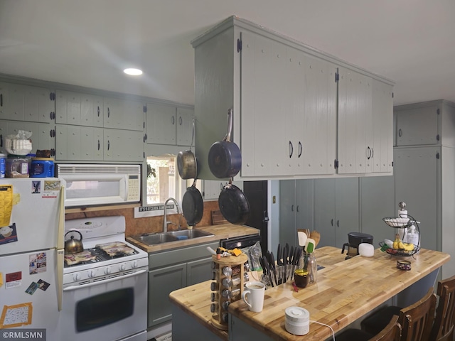 kitchen with sink, white appliances, and gray cabinetry