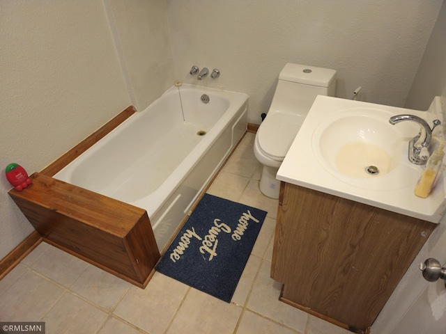 bathroom with tile patterned flooring, a bathing tub, toilet, and vanity