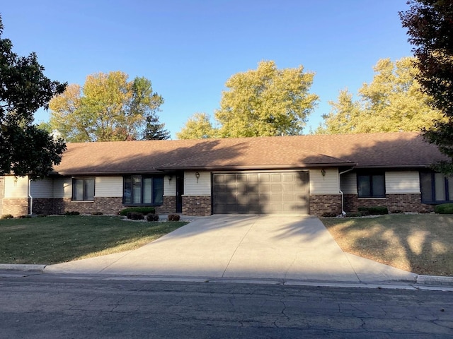 single story home featuring a front yard and a garage