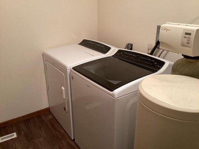 clothes washing area with independent washer and dryer and dark hardwood / wood-style floors