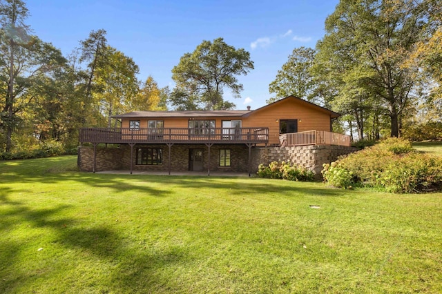 rear view of property featuring a lawn and a wooden deck