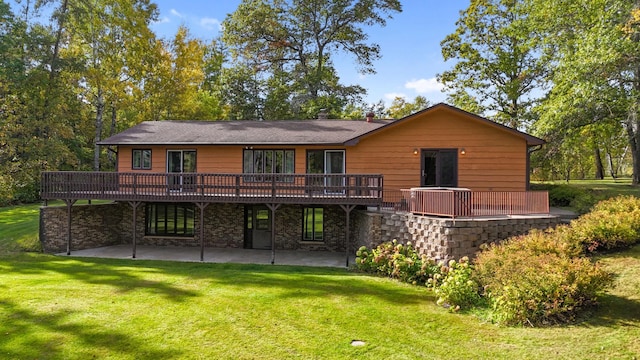 back of house featuring a wooden deck and a lawn