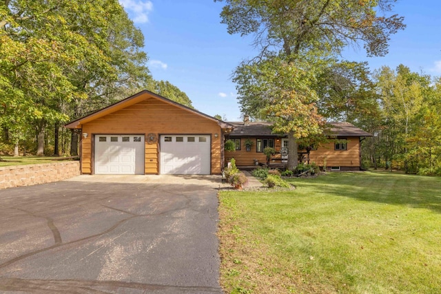 view of front of property featuring a garage and a front lawn