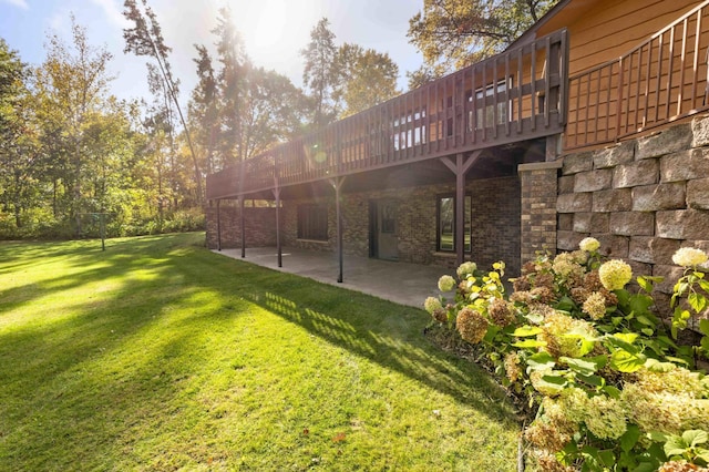 view of yard with a wooden deck and a patio area