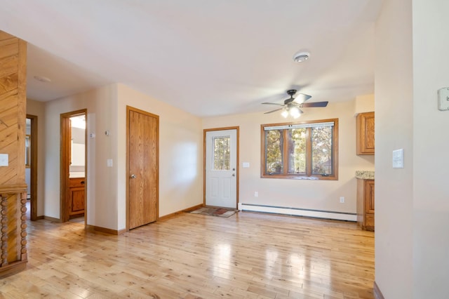 unfurnished living room featuring a baseboard radiator, light hardwood / wood-style floors, and ceiling fan