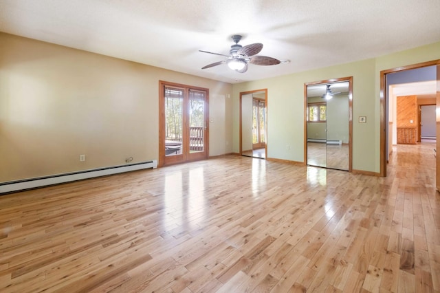 empty room featuring a baseboard radiator, light hardwood / wood-style floors, ceiling fan, and a textured ceiling