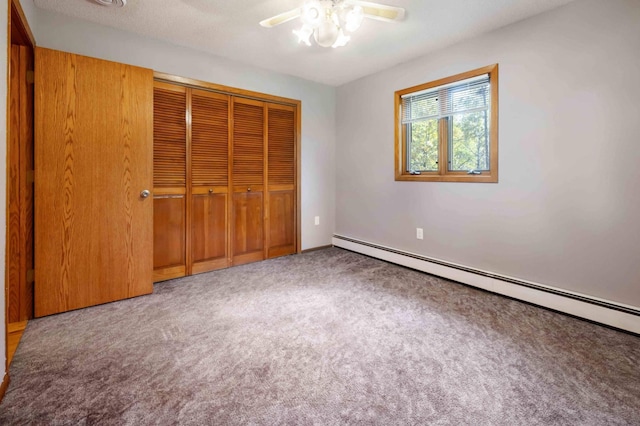 unfurnished bedroom with carpet, ceiling fan, a baseboard radiator, and a closet