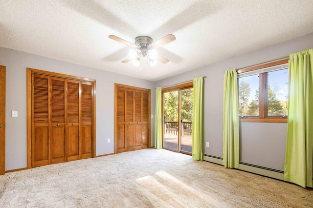 unfurnished bedroom featuring a textured ceiling, access to outside, light carpet, and ceiling fan