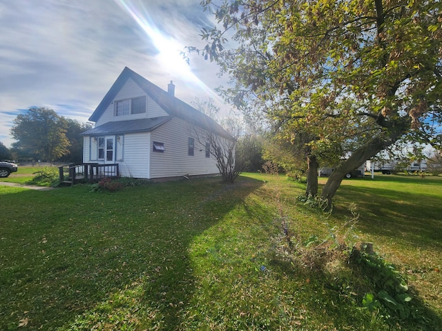 view of side of home with a lawn