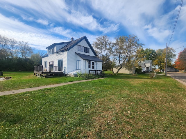 view of side of home with a yard and a wooden deck