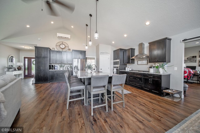 dining room with ceiling fan, dark hardwood / wood-style flooring, sink, an AC wall unit, and high vaulted ceiling