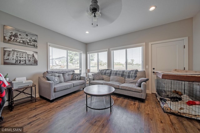 living room featuring hardwood / wood-style floors and ceiling fan