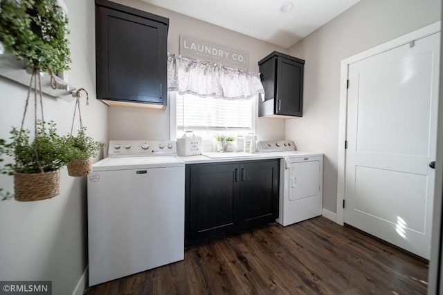 clothes washing area featuring washing machine and clothes dryer, cabinets, dark hardwood / wood-style flooring, and sink