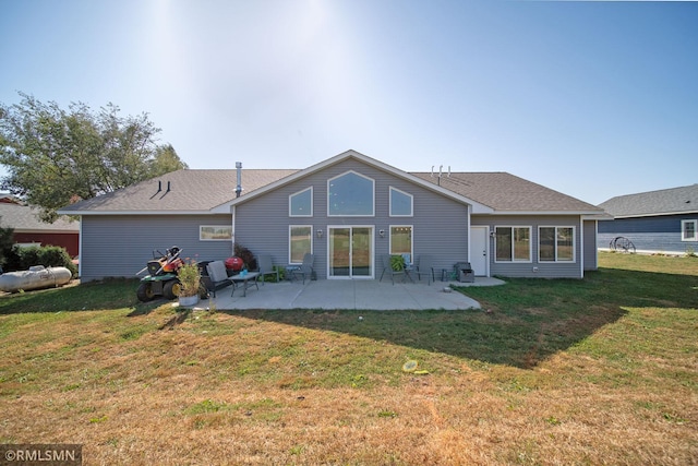 back of house with a patio and a lawn