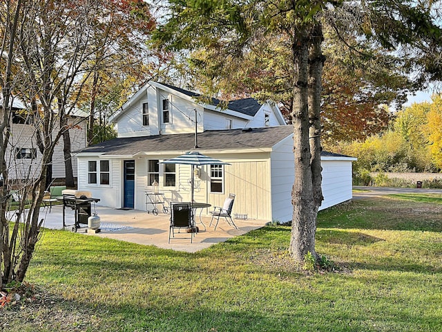 back of property with a yard and a patio area