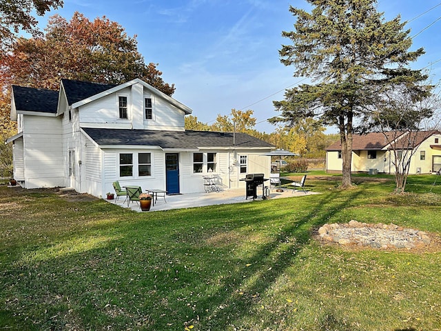 back of house featuring a patio and a yard