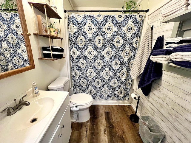 full bathroom featuring wood-type flooring, vanity, shower / tub combo, and toilet