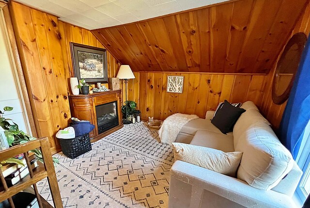 living room featuring wood walls and vaulted ceiling