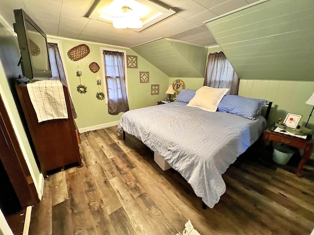 bedroom featuring wood-type flooring and lofted ceiling