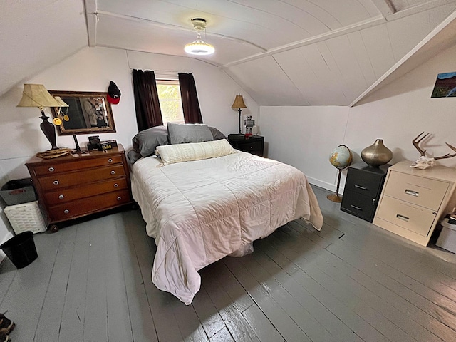 bedroom with ceiling fan, vaulted ceiling, and dark hardwood / wood-style flooring