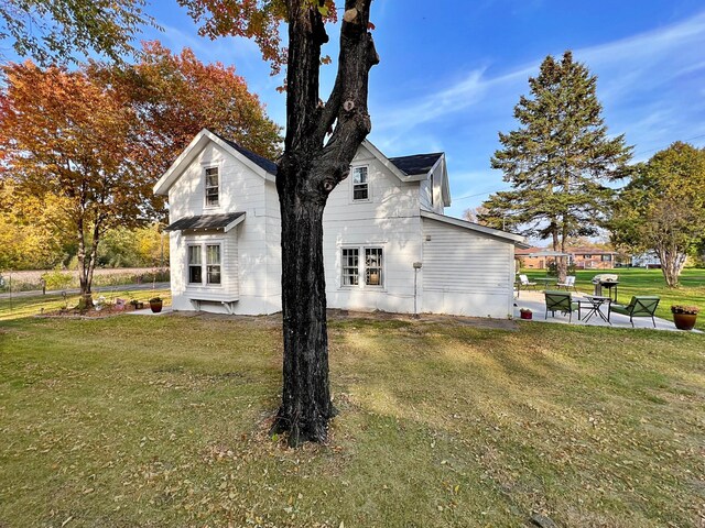 view of home's exterior with a yard