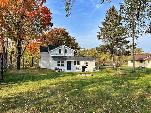 back of property featuring a yard