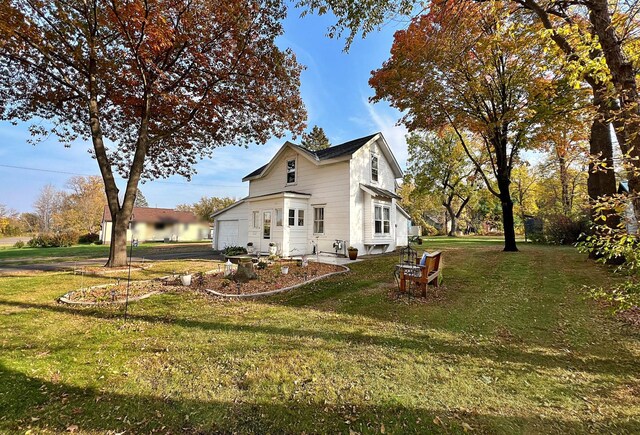 view of side of home with a yard