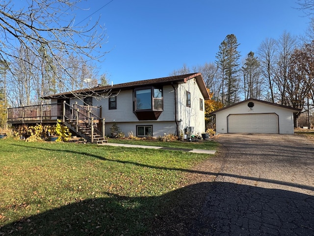 view of front facade featuring an outdoor structure, a front lawn, a deck, and a garage