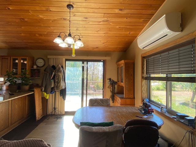 dining space with a wall mounted AC, lofted ceiling, a wealth of natural light, and hardwood / wood-style floors