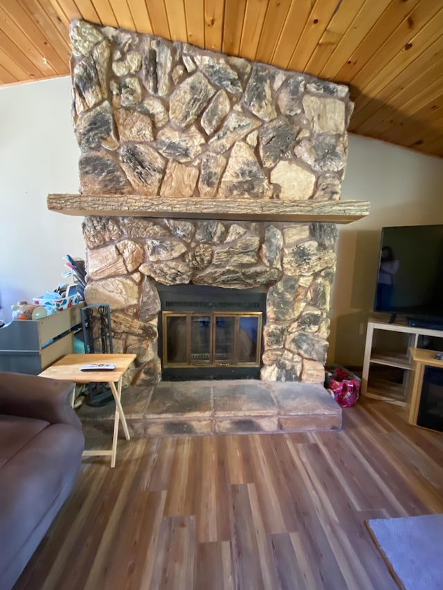 living room with wood ceiling, hardwood / wood-style floors, a fireplace, and vaulted ceiling