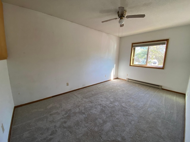 carpeted empty room with ceiling fan and a baseboard heating unit