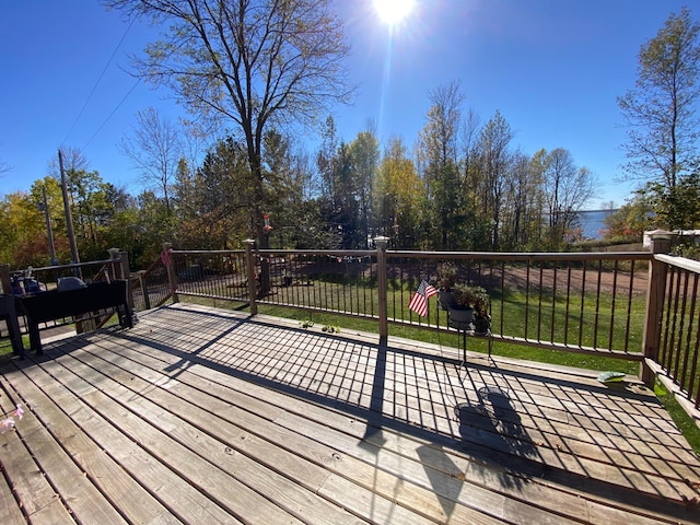 wooden deck with a lawn