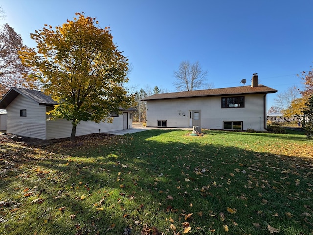 rear view of property with a yard