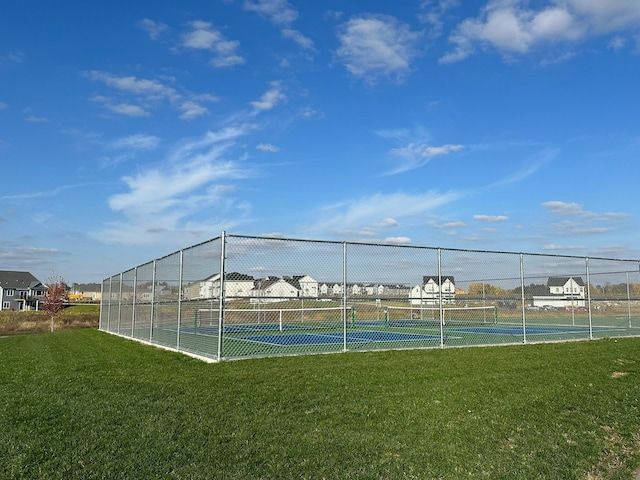 view of sport court featuring a lawn