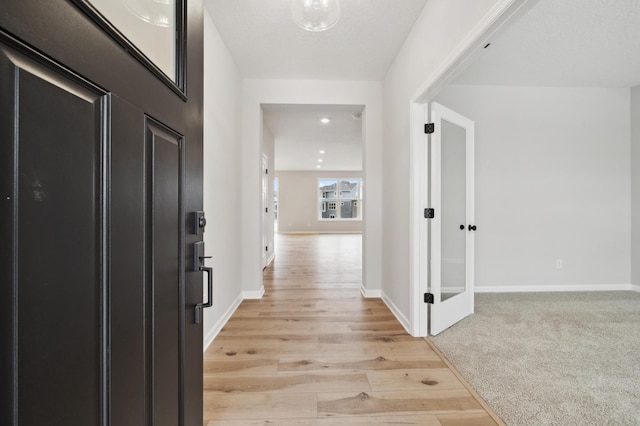 corridor with light wood-type flooring