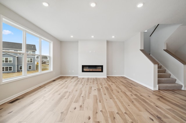 unfurnished living room with light hardwood / wood-style floors