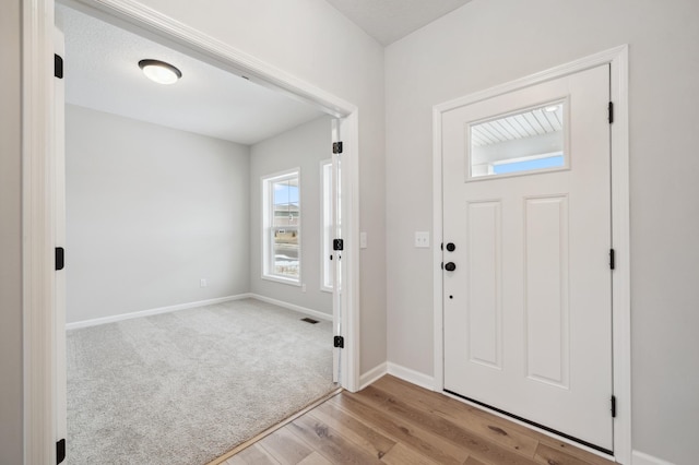 view of carpeted foyer