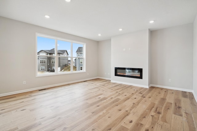 unfurnished living room with light hardwood / wood-style flooring