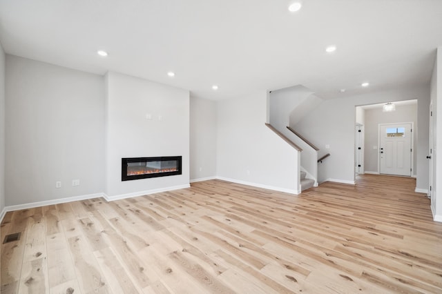 unfurnished living room featuring light wood-type flooring