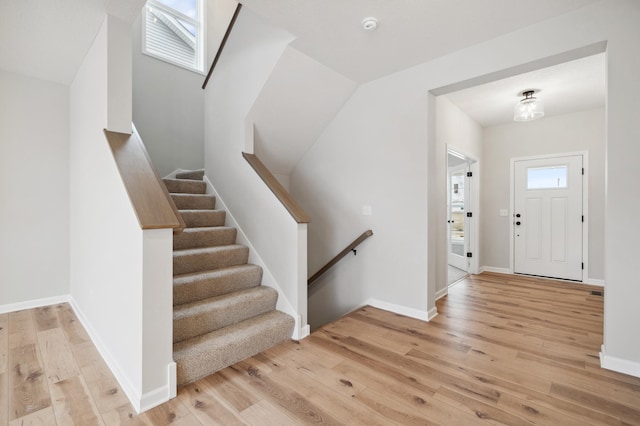 entryway with a skylight, plenty of natural light, and light hardwood / wood-style flooring