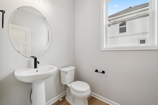 bathroom featuring hardwood / wood-style flooring, sink, and toilet