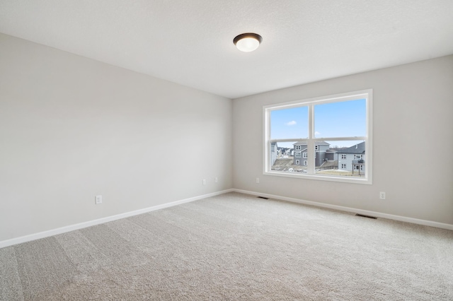 spare room featuring carpet floors